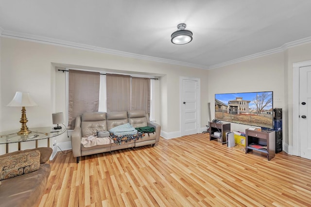 living area with wood finished floors, baseboards, and ornamental molding