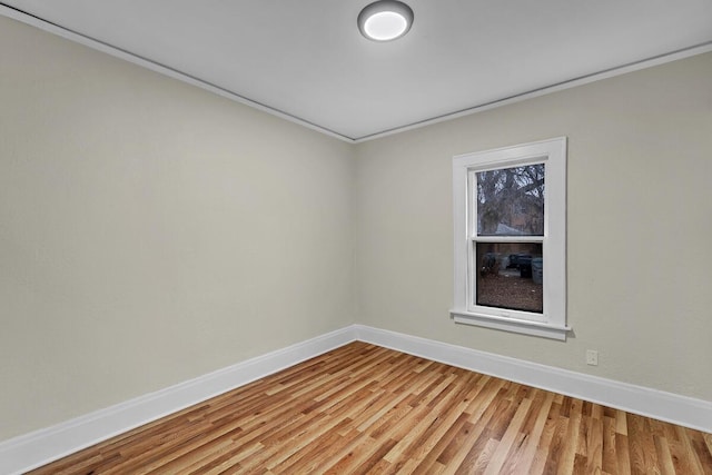 unfurnished room with baseboards and light wood-style floors