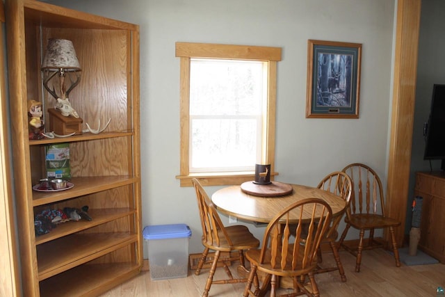 dining space with wood finished floors