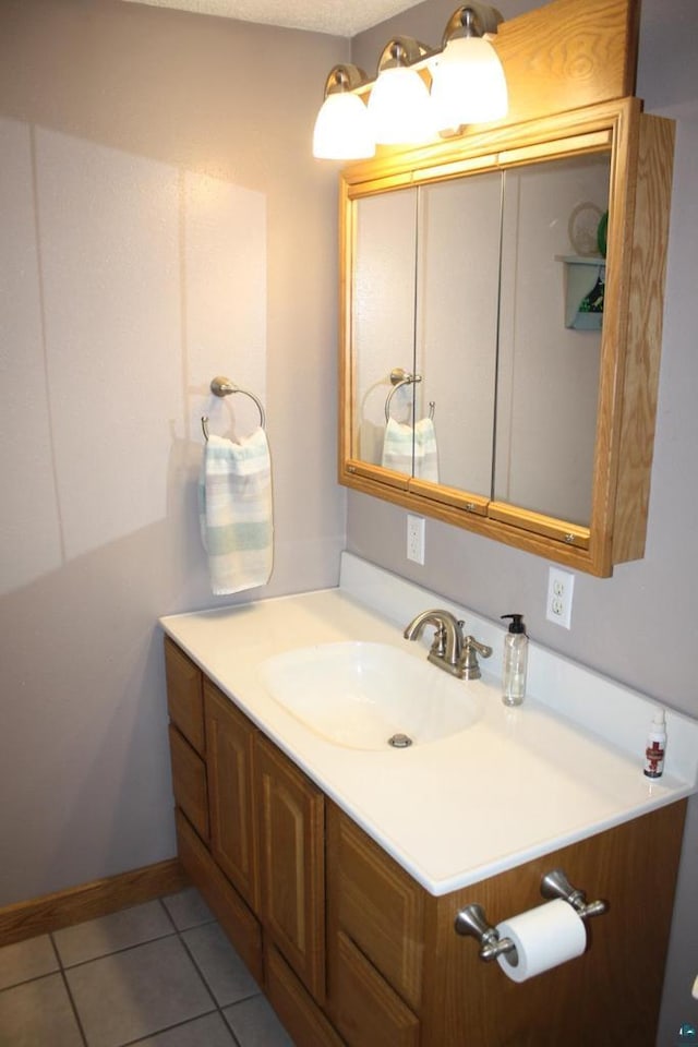 bathroom with tile patterned floors and vanity