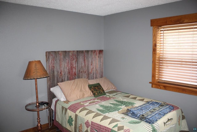 bedroom featuring multiple windows and a textured ceiling