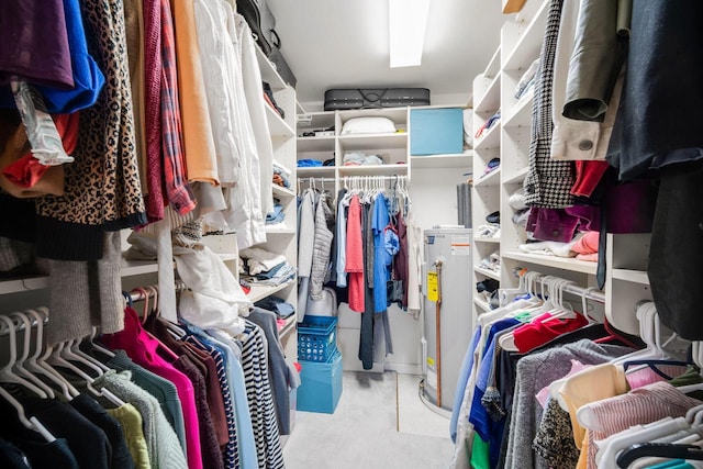 walk in closet with carpet flooring