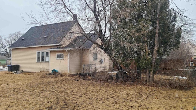 back of house featuring fence