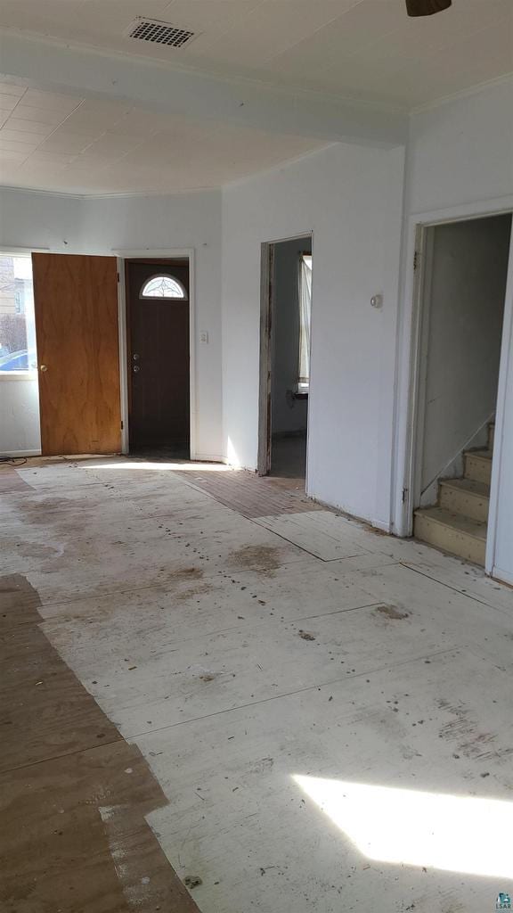 entrance foyer with stairway, visible vents, and a wealth of natural light