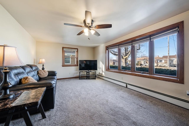 carpeted living room featuring plenty of natural light, a ceiling fan, baseboards, and baseboard heating