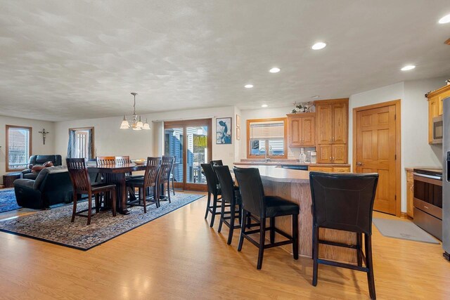 dining space featuring recessed lighting, a chandelier, and light wood-style flooring