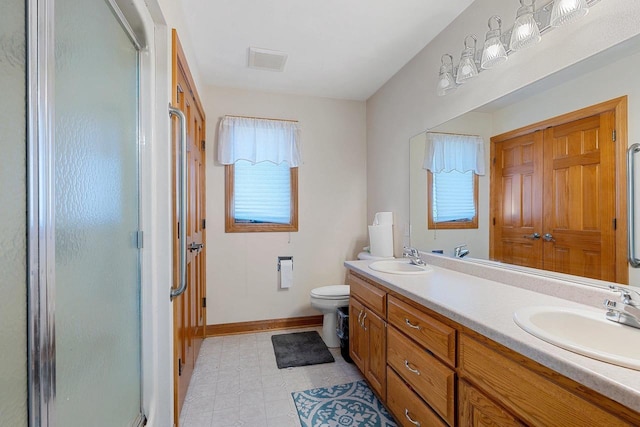 bathroom featuring a healthy amount of sunlight, a stall shower, and a sink