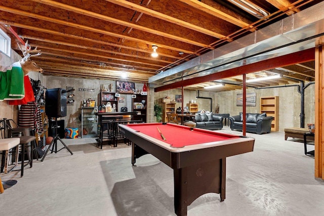 recreation room with a bar, pool table, and concrete floors