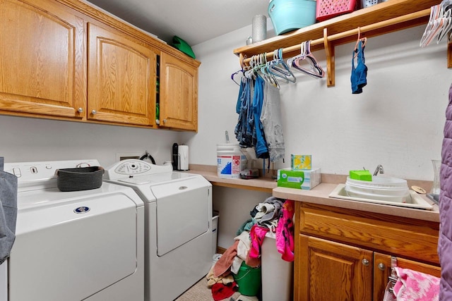 laundry area with washer and dryer and cabinet space