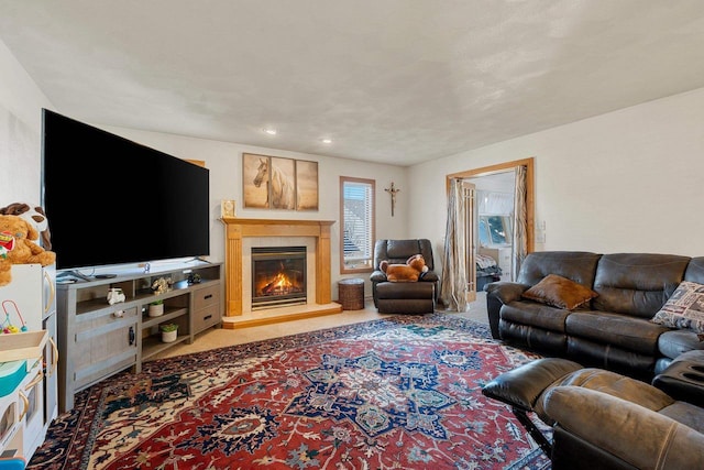 living area with carpet and a glass covered fireplace