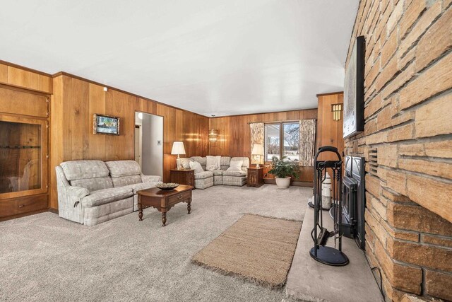 living room featuring wooden walls and carpet flooring