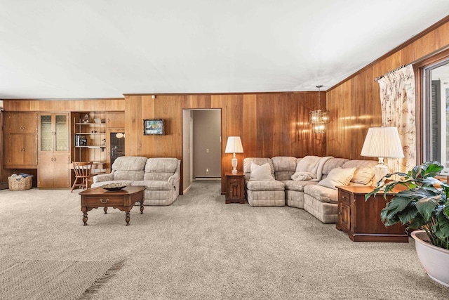 living room featuring wooden walls, carpet flooring, baseboard heating, and ornamental molding