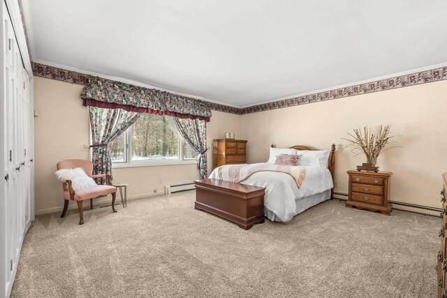 bedroom featuring a baseboard heating unit, carpet, and crown molding