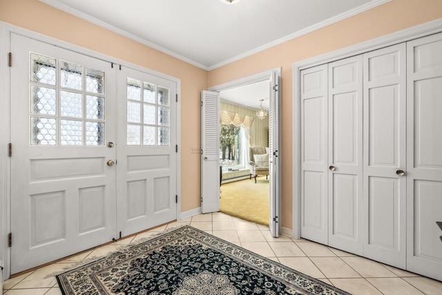 foyer entrance with baseboards, ornamental molding, light carpet, french doors, and light tile patterned flooring