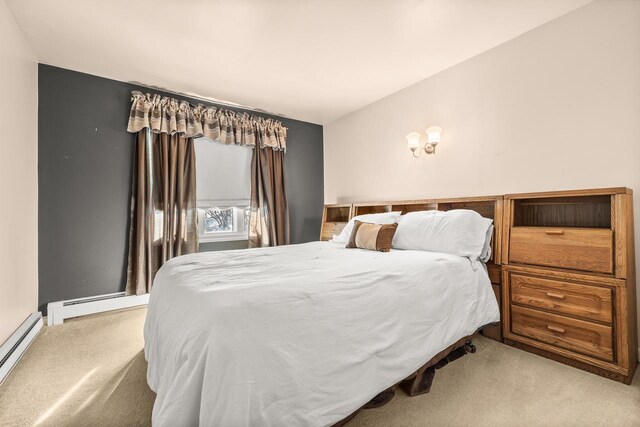 bedroom featuring a baseboard radiator, carpet floors, baseboard heating, and lofted ceiling