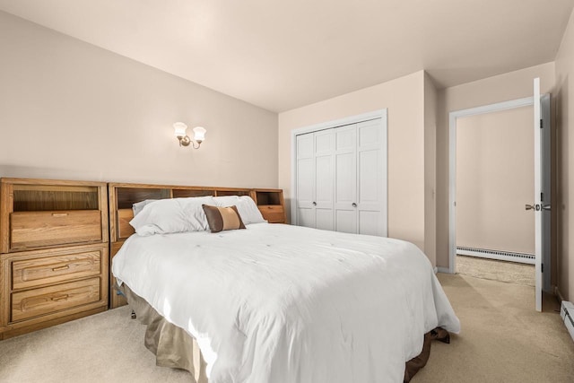 bedroom with a closet, baseboard heating, and light carpet