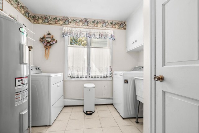 laundry area with light tile patterned flooring, cabinet space, separate washer and dryer, water heater, and baseboard heating