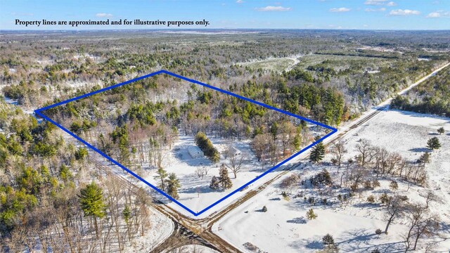 birds eye view of property featuring a wooded view