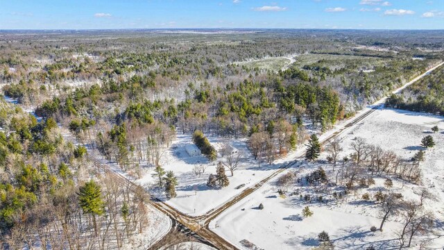 birds eye view of property with a forest view