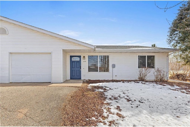 single story home featuring an attached garage and driveway