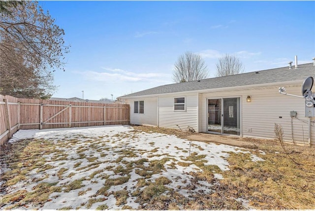 rear view of house featuring fence