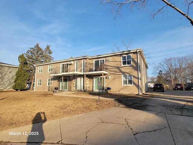 rear view of property featuring a balcony