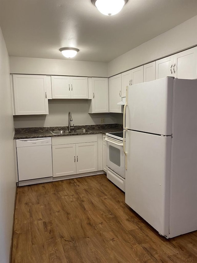 kitchen with dark wood-style flooring, white cabinets, white appliances, and a sink