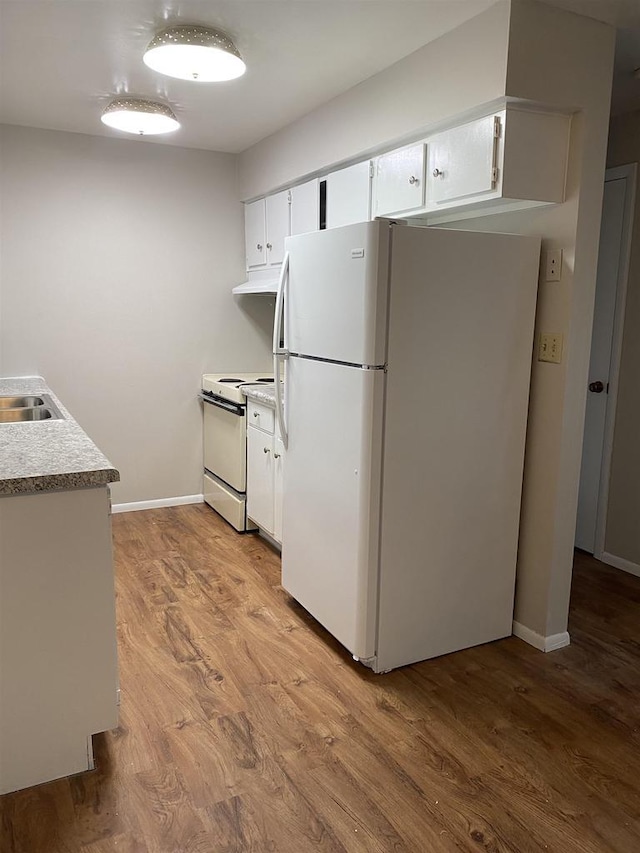 kitchen featuring under cabinet range hood, light wood-type flooring, white appliances, and white cabinets