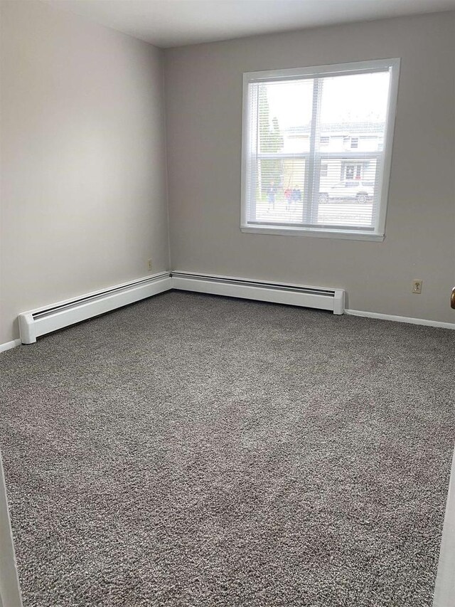 carpeted spare room with baseboards