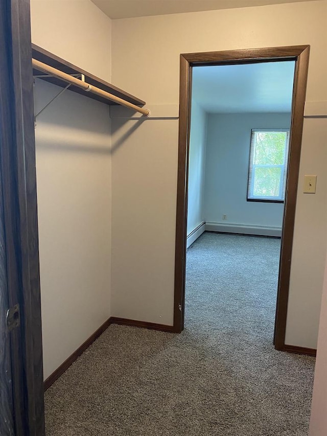 walk in closet featuring a baseboard radiator, carpet floors, and baseboard heating