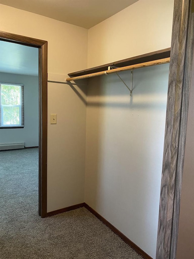 walk in closet featuring carpet flooring and a baseboard heating unit