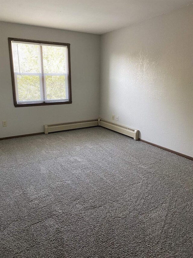 carpeted spare room with baseboards