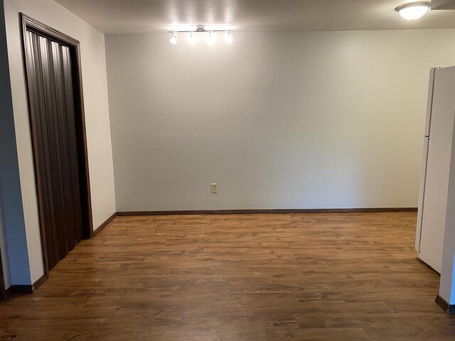 empty room with wood finished floors and baseboards