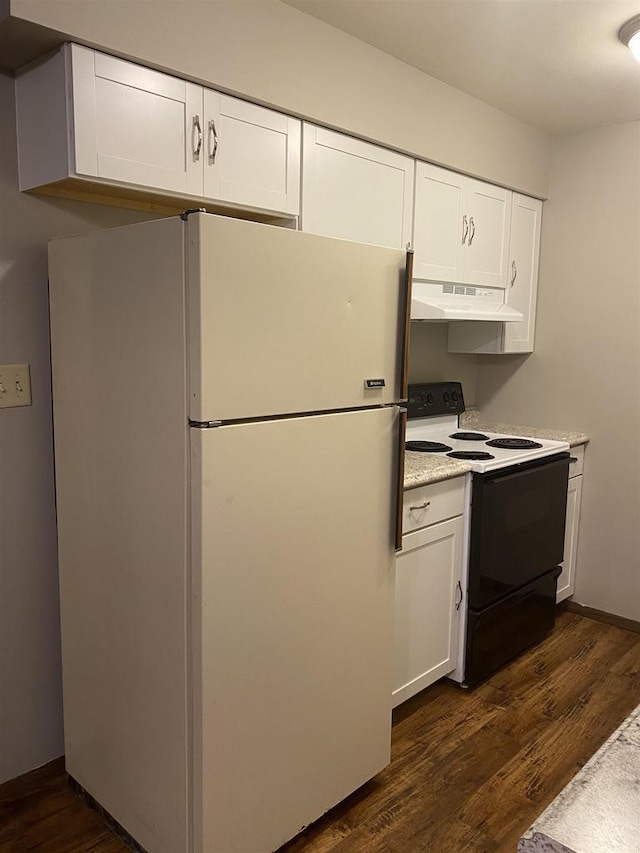 kitchen with under cabinet range hood, freestanding refrigerator, electric stove, and dark wood-style flooring