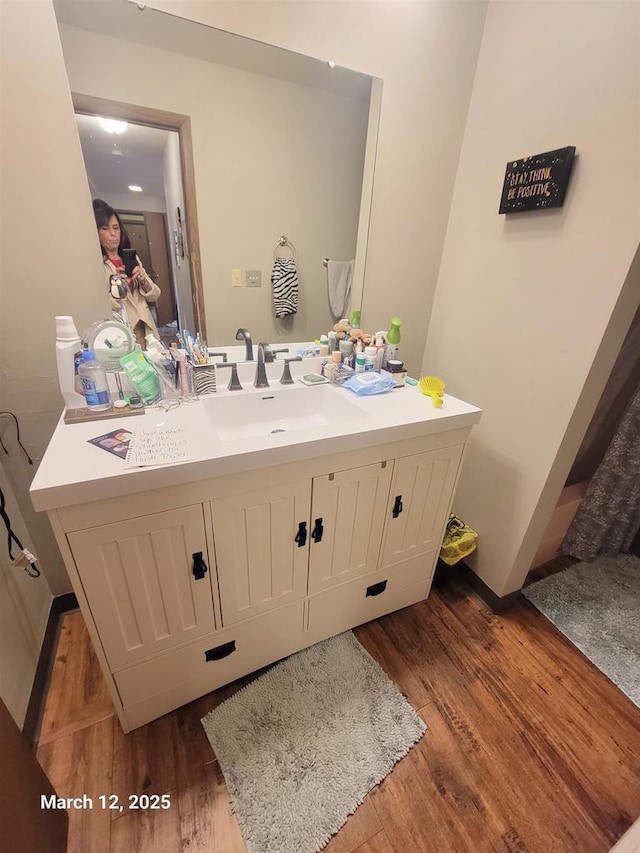 bathroom featuring vanity and wood finished floors