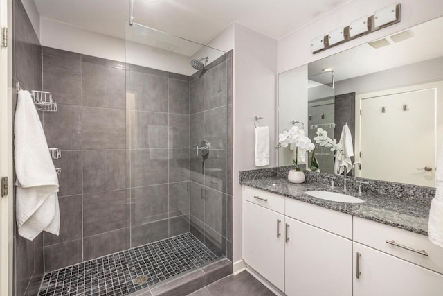 full bath with vanity and a stall shower