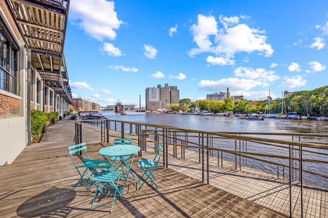 wooden terrace featuring a water view