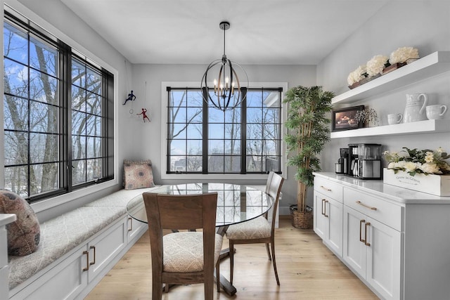 dining area featuring light wood-style flooring and a chandelier