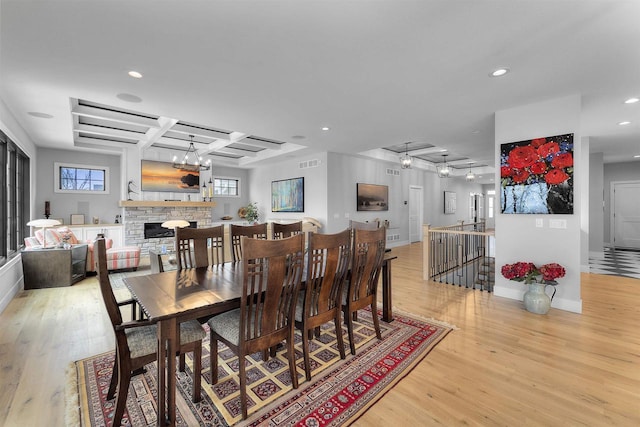 dining space featuring light wood finished floors, visible vents, recessed lighting, and coffered ceiling