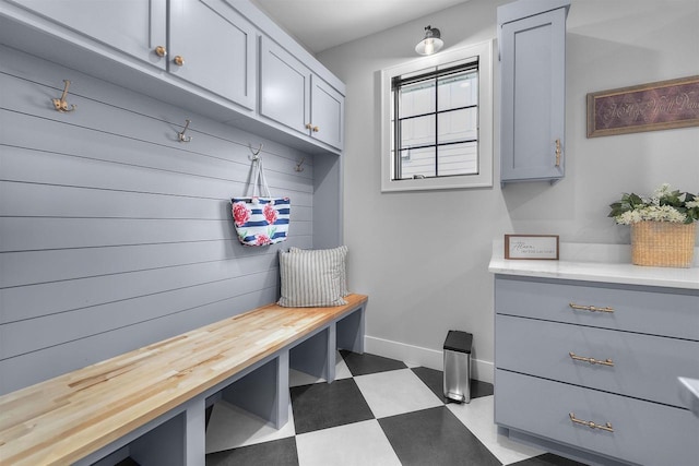 mudroom featuring tile patterned floors and baseboards