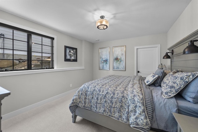 carpeted bedroom featuring baseboards