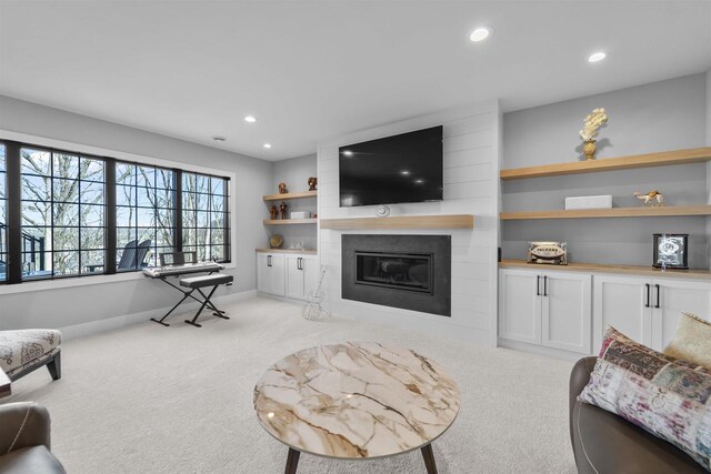 living room featuring carpet flooring, recessed lighting, and a large fireplace