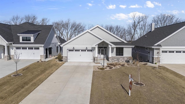 view of front of property featuring an attached garage, stone siding, driveway, and a shingled roof