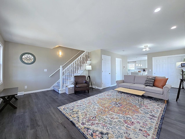 living room featuring dark wood-style floors, stairway, recessed lighting, and baseboards