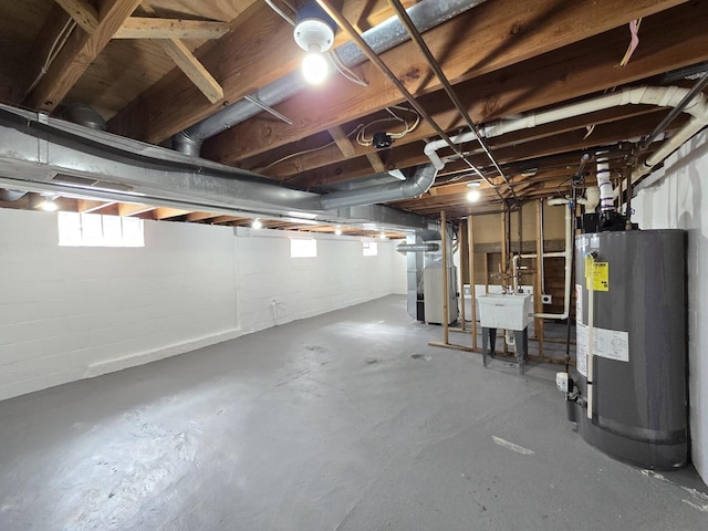 basement with gas water heater, heating unit, and a sink