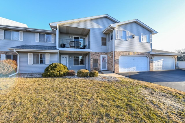 townhome / multi-family property featuring aphalt driveway, a front yard, a garage, a balcony, and stone siding