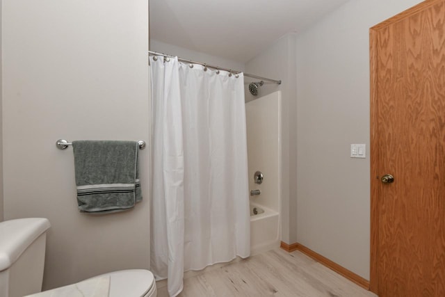 bathroom with shower / bathtub combination with curtain, baseboards, toilet, and wood finished floors