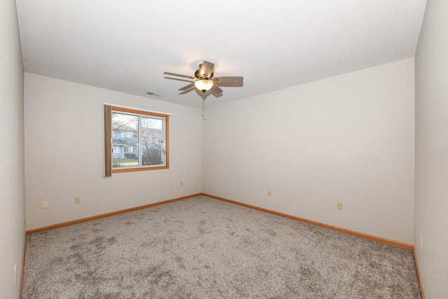 spare room with baseboards, carpet, and ceiling fan