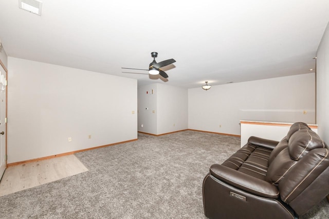 interior space featuring visible vents, carpet flooring, a ceiling fan, and baseboards