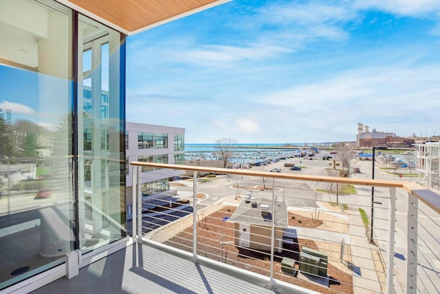 balcony featuring a view of city and a water view